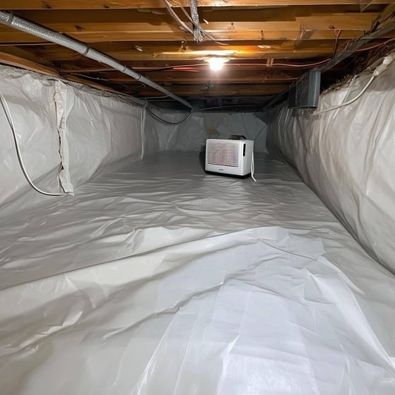 crawlspace encapsulated with a dehumidifier in a corner