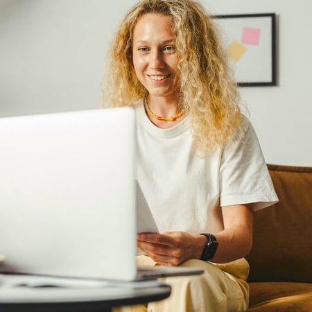 A person sitting in front of a laptop