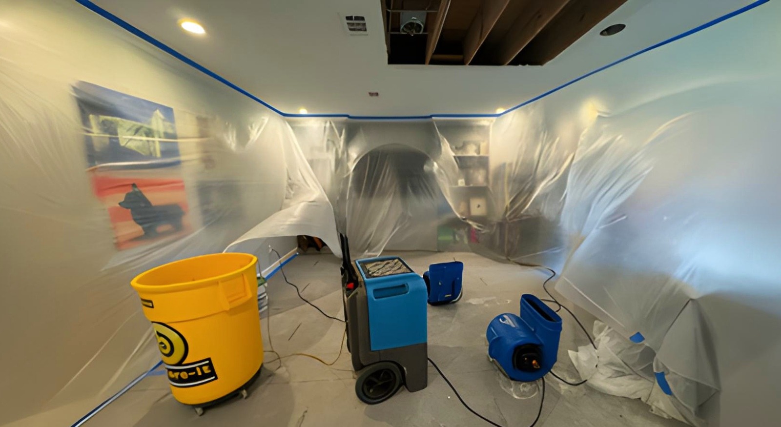 House in the middle of water damage mitigation with dehumidifiers and air movers